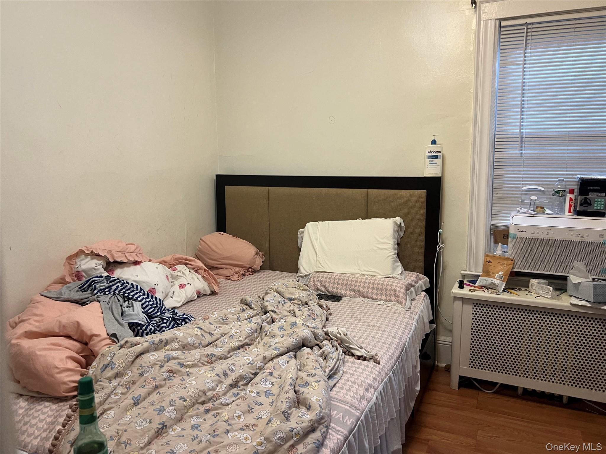 151-08 33rd Road Queens, NY 11354 - Photo 18 of 22 a bedroom with a bed and a window