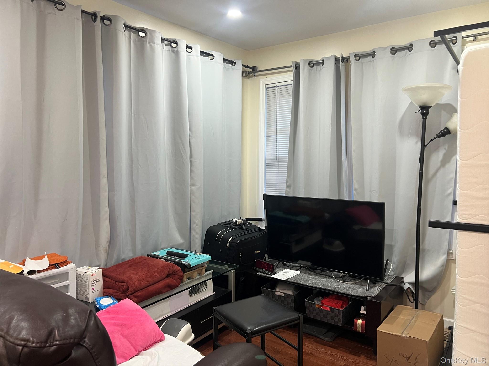 151-08 33rd Road Queens, NY 11354 - Photo 2 of 22 a bedroom with a bed and a window