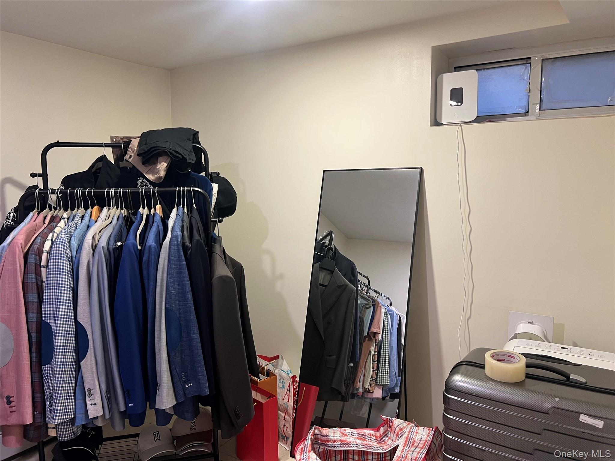 151-08 33rd Road Queens, NY 11354 - Photo 21 of 22 a view of walk in closet with clothes and shoes