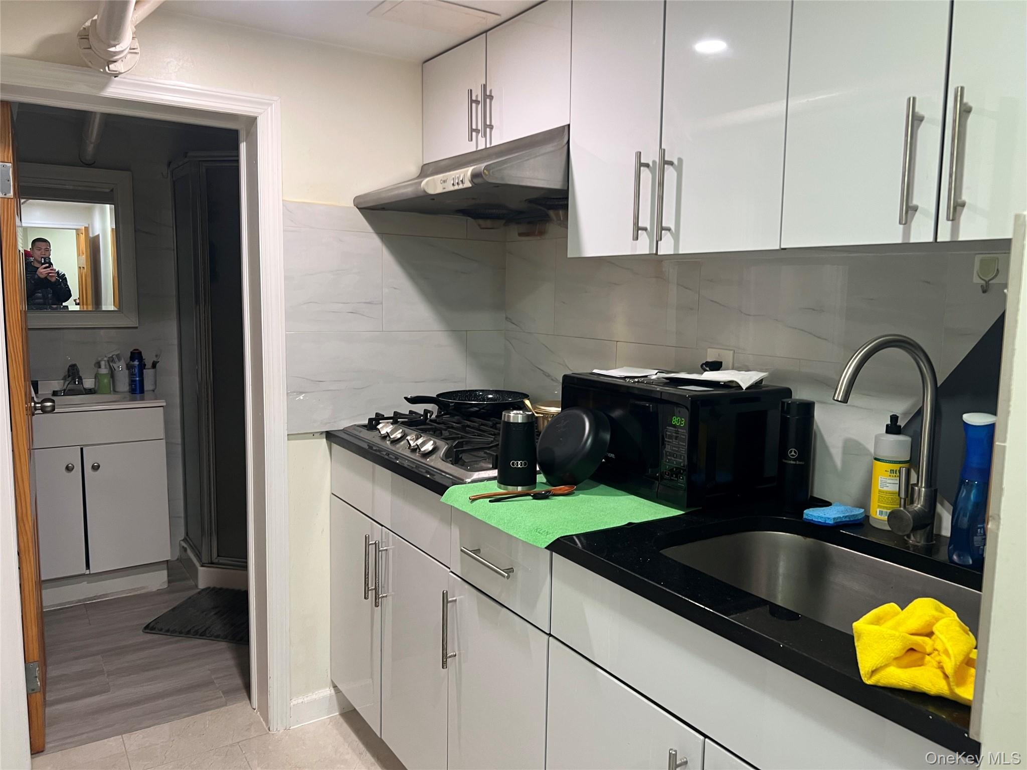 151-08 33rd Road Queens, NY 11354 - Photo 3 of 22 a kitchen with sink and cabinets