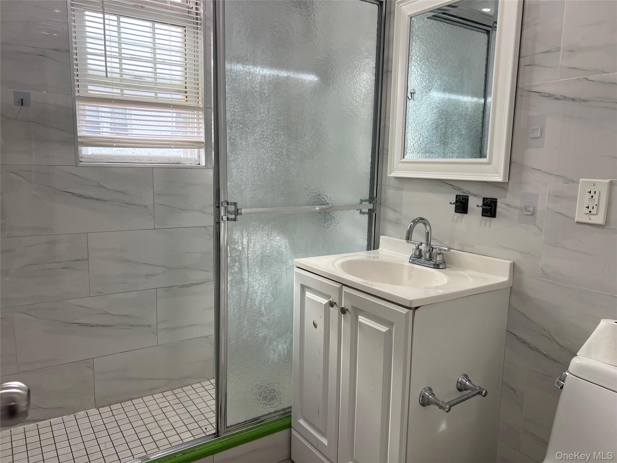 151-08 33rd Road Queens, NY 11354 - Photo 7 of 22 a bathroom with a sink a toilet and shower