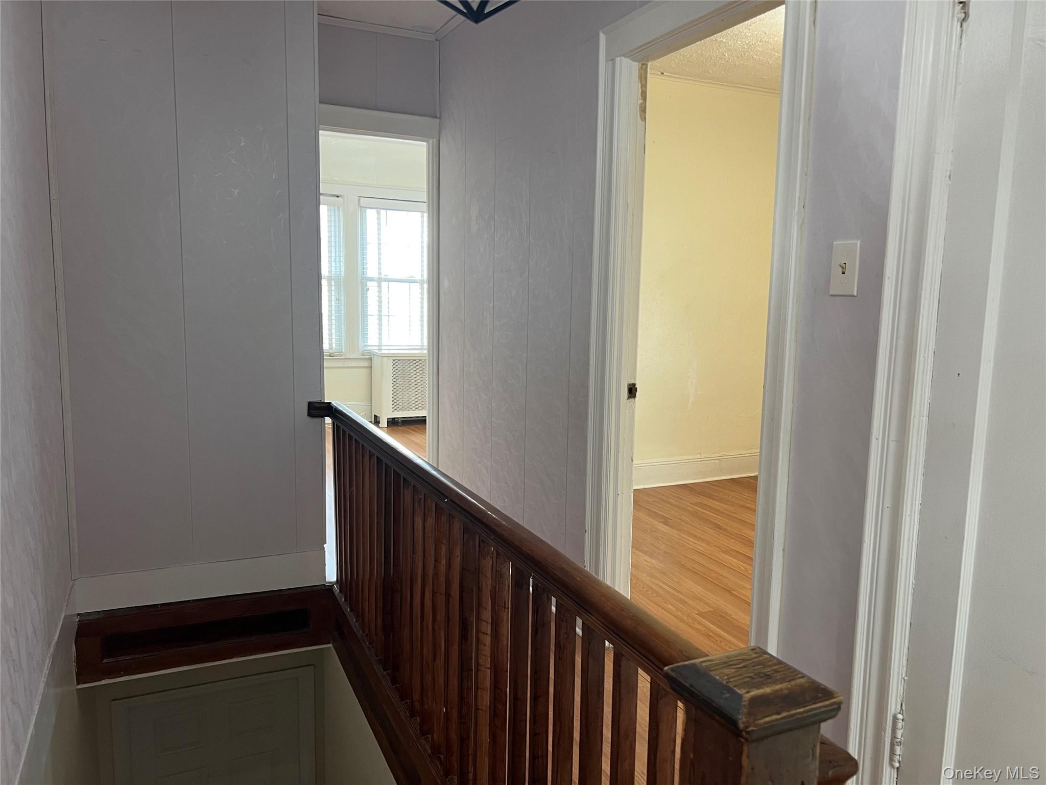 151-08 33rd Road Queens, NY 11354 - Photo 9 of 22 a view of a hallway with wooden floor and staircase