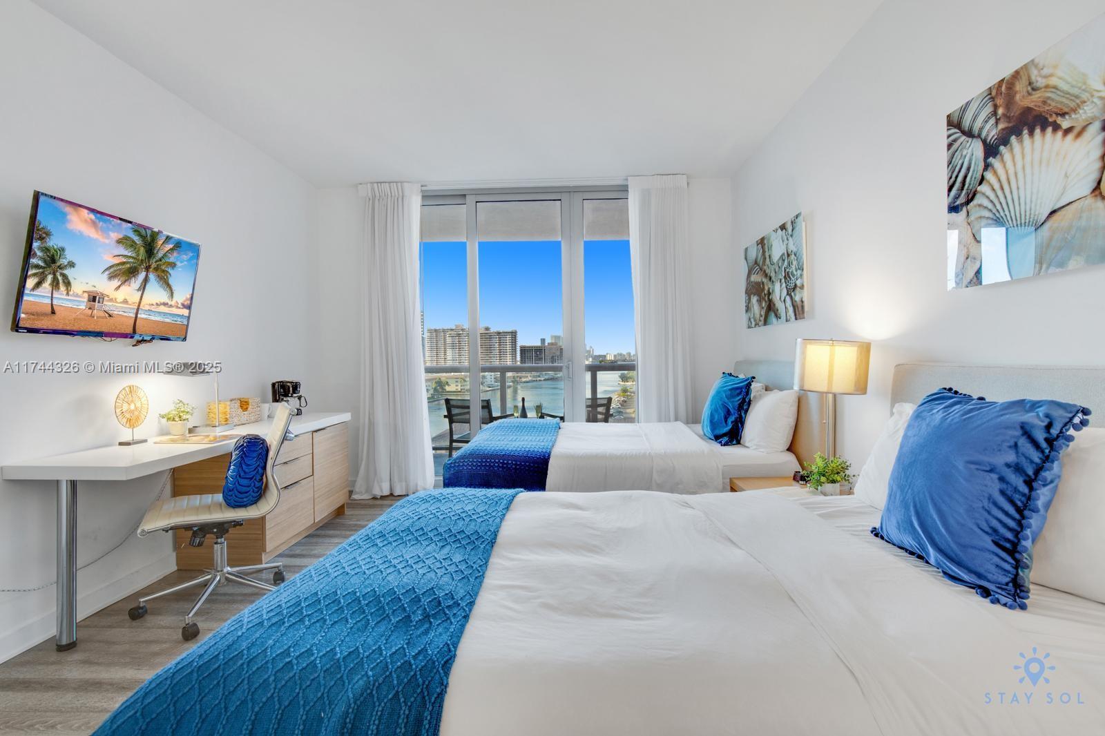 2602 East Hallandale Beach Boulevard, Unit R506 Hallandale Beach, FL 33009 - Photo 3 of 15 a bed room with a bed and a window