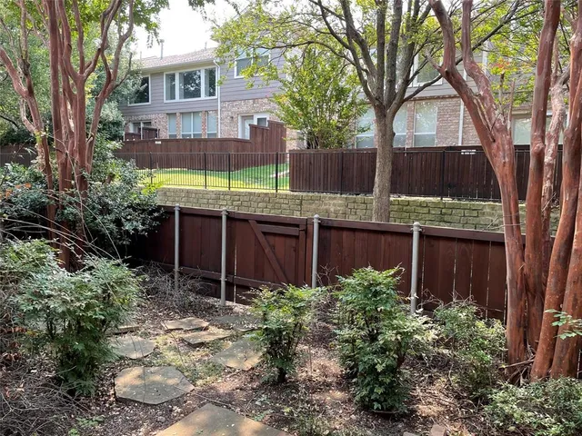 a view of a house with a yard and tree s