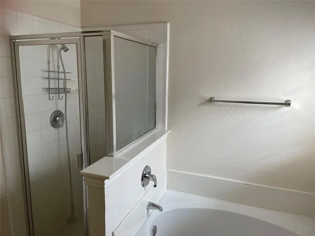a bathroom with a shower and a tub