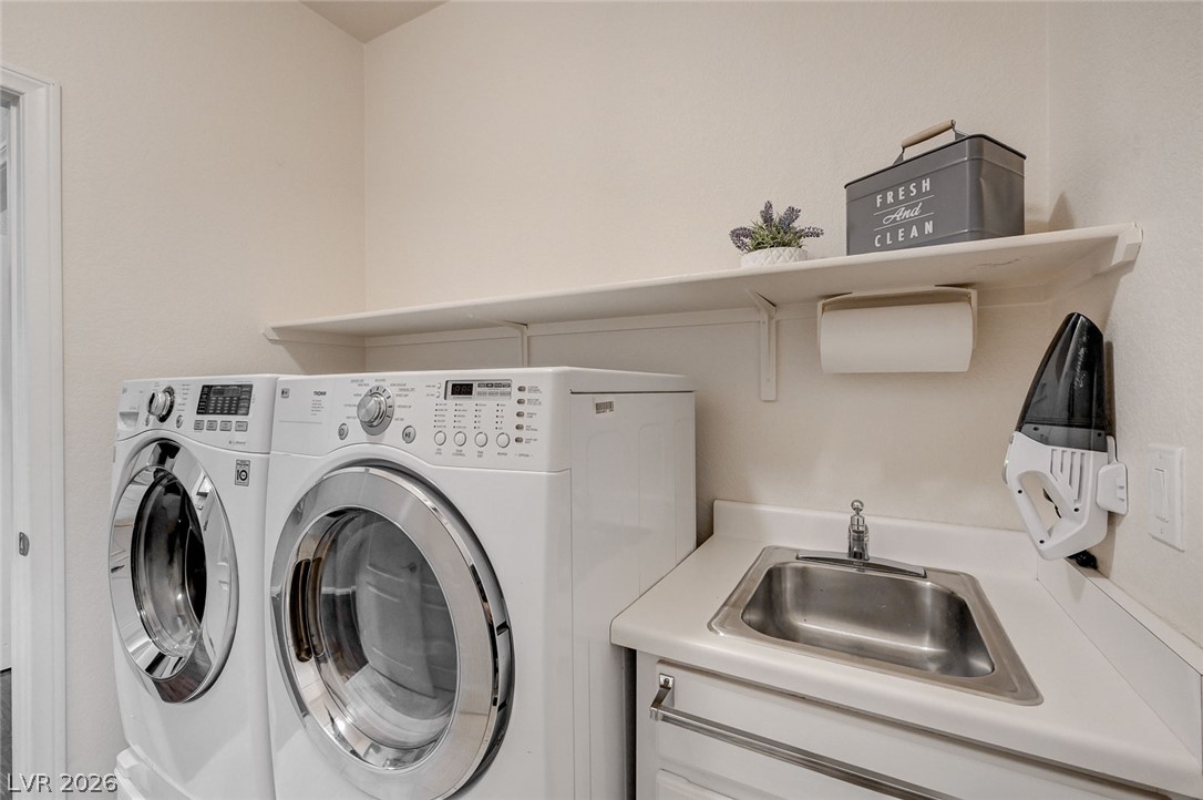 1604 Cattle Ranch Place Henderson, NV 89002 - Photo 62 of 99 Functional laundry space featuring a practical utility sink and convenient shelving.