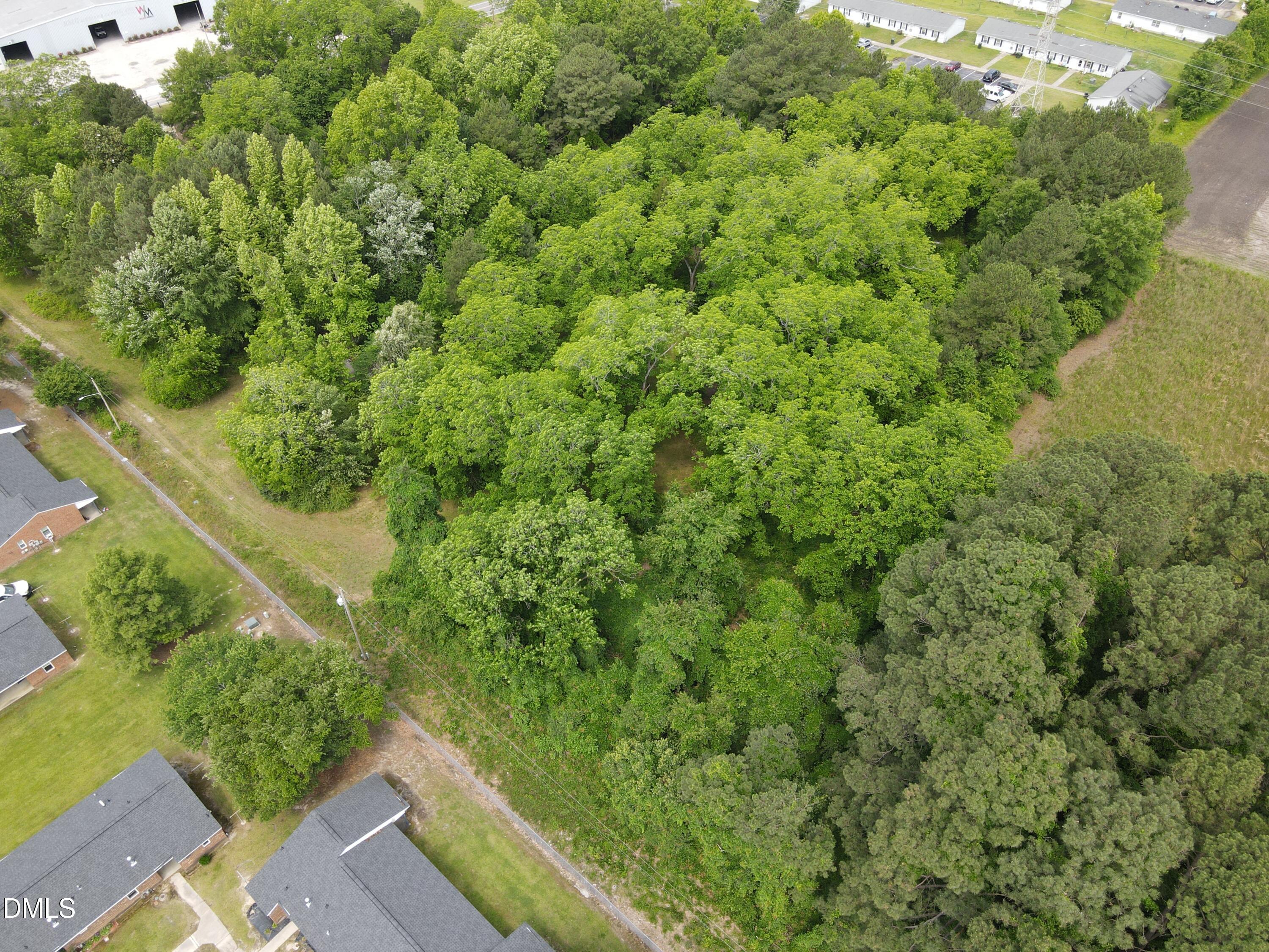 1708-1710 London Church Road Northeast Wilson, NC 27893 - Photo 18 of 27 a view of a yard with plants and wooden fence