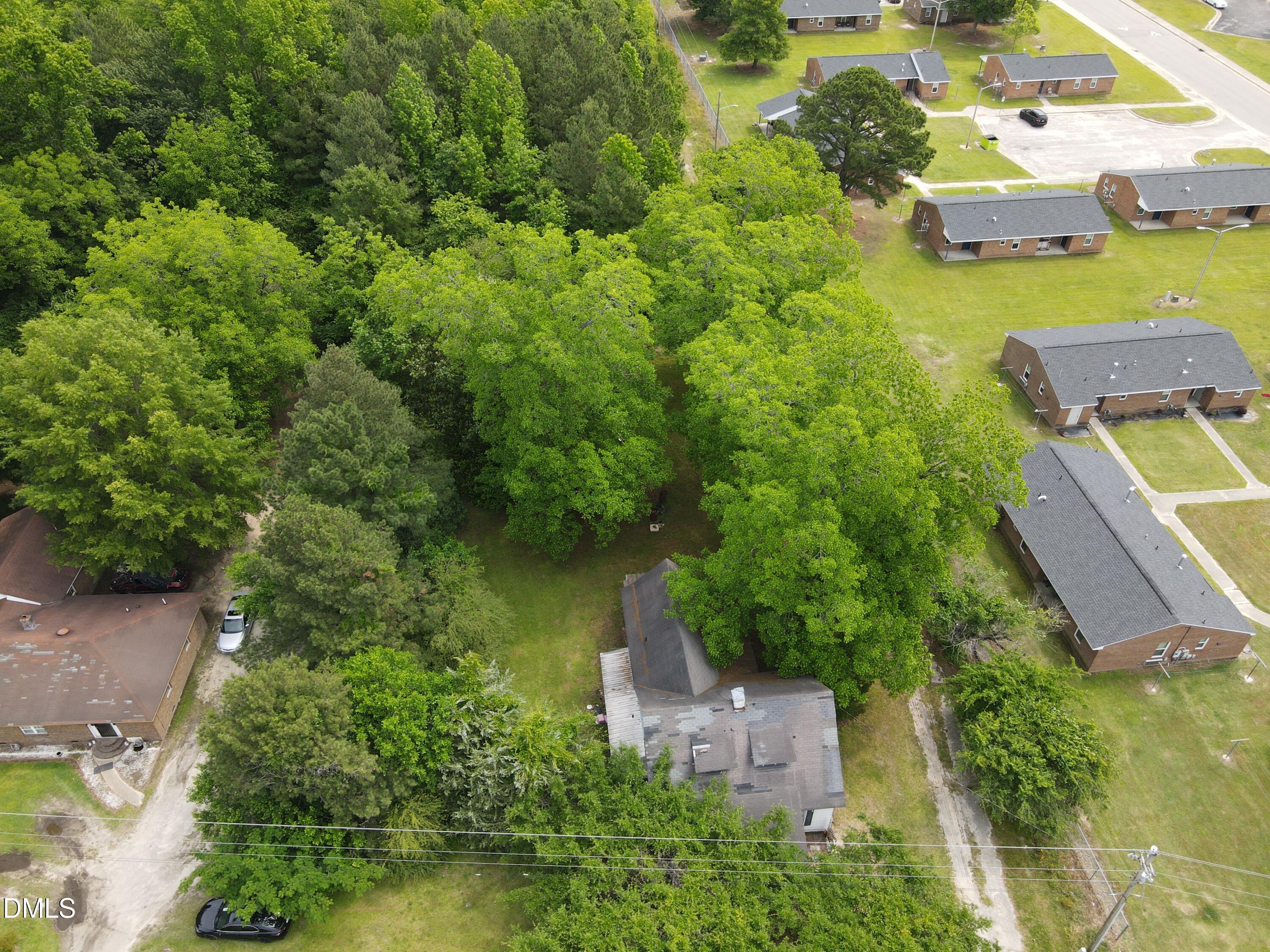 1708-1710 London Church Road Northeast Wilson, NC 27893 - Photo 5 of 27 an aerial view of a house with a yard and lake view