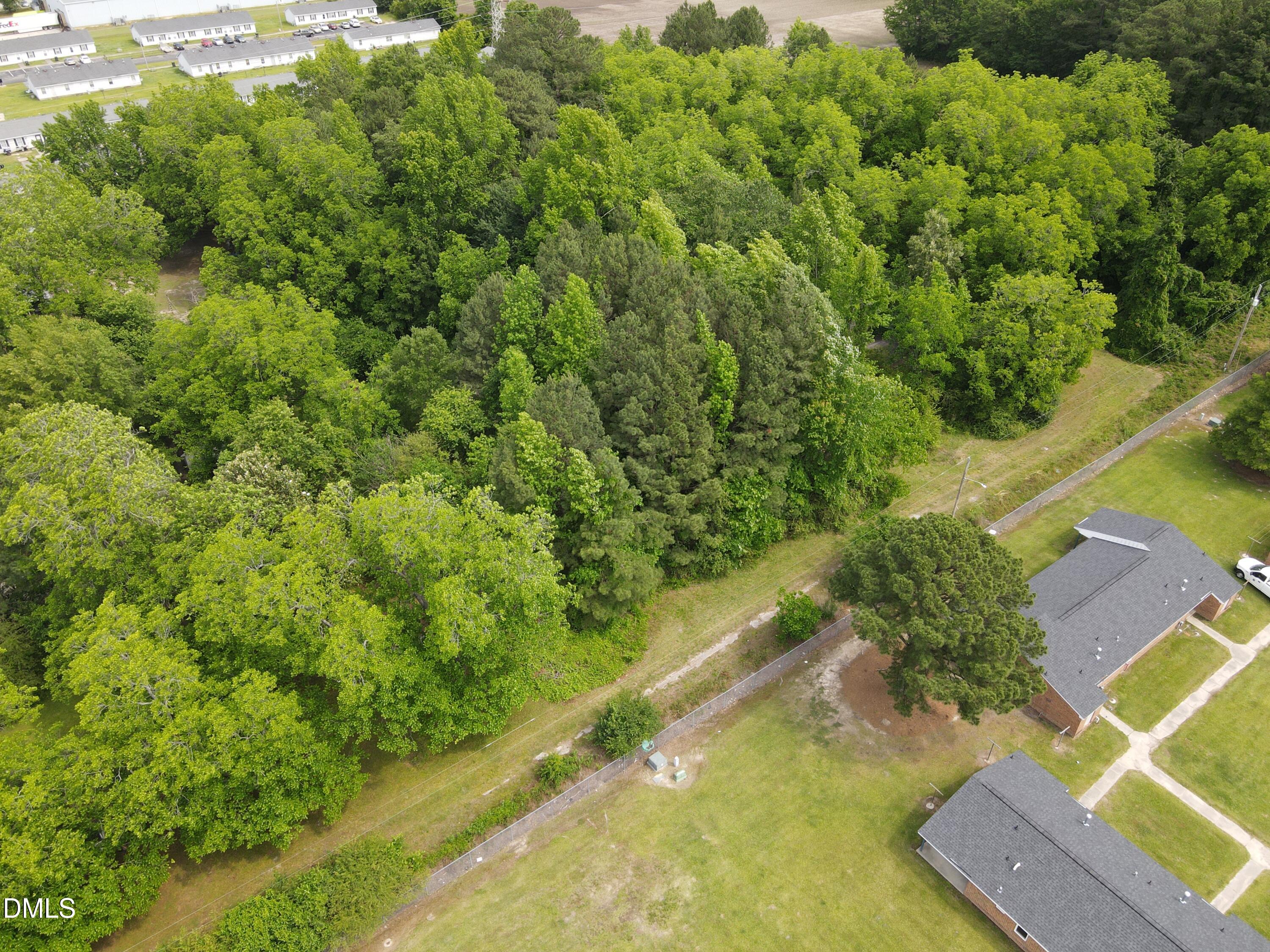 1708-1710 London Church Road Northeast Wilson, NC 27893 - Photo 9 of 27 a view of a yard with plants and large trees