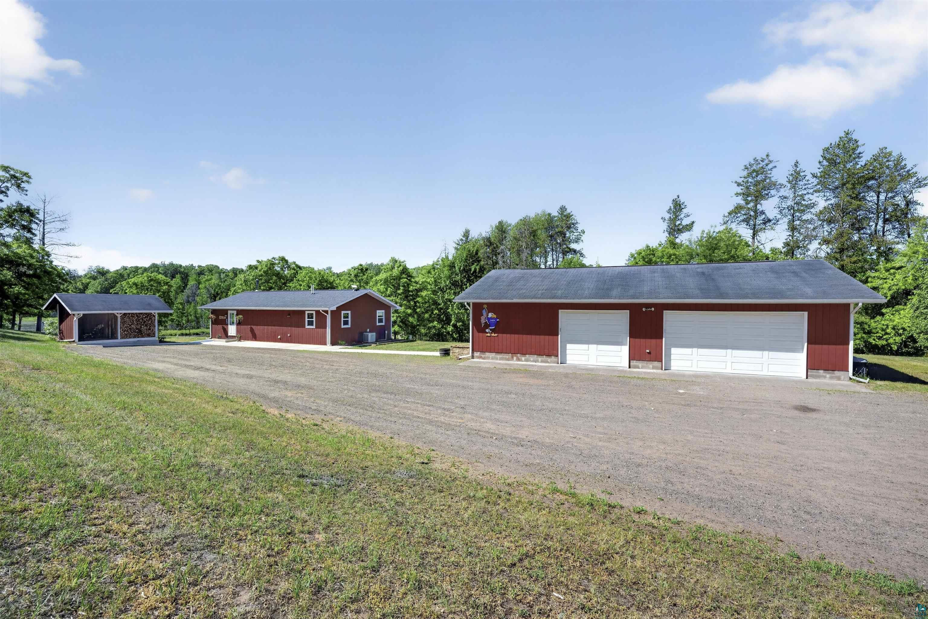 11702 East Mail Road Gordon, WI 54838 - Photo 55 of 60 Outbuilding featuring two white garage doors and a red exterior