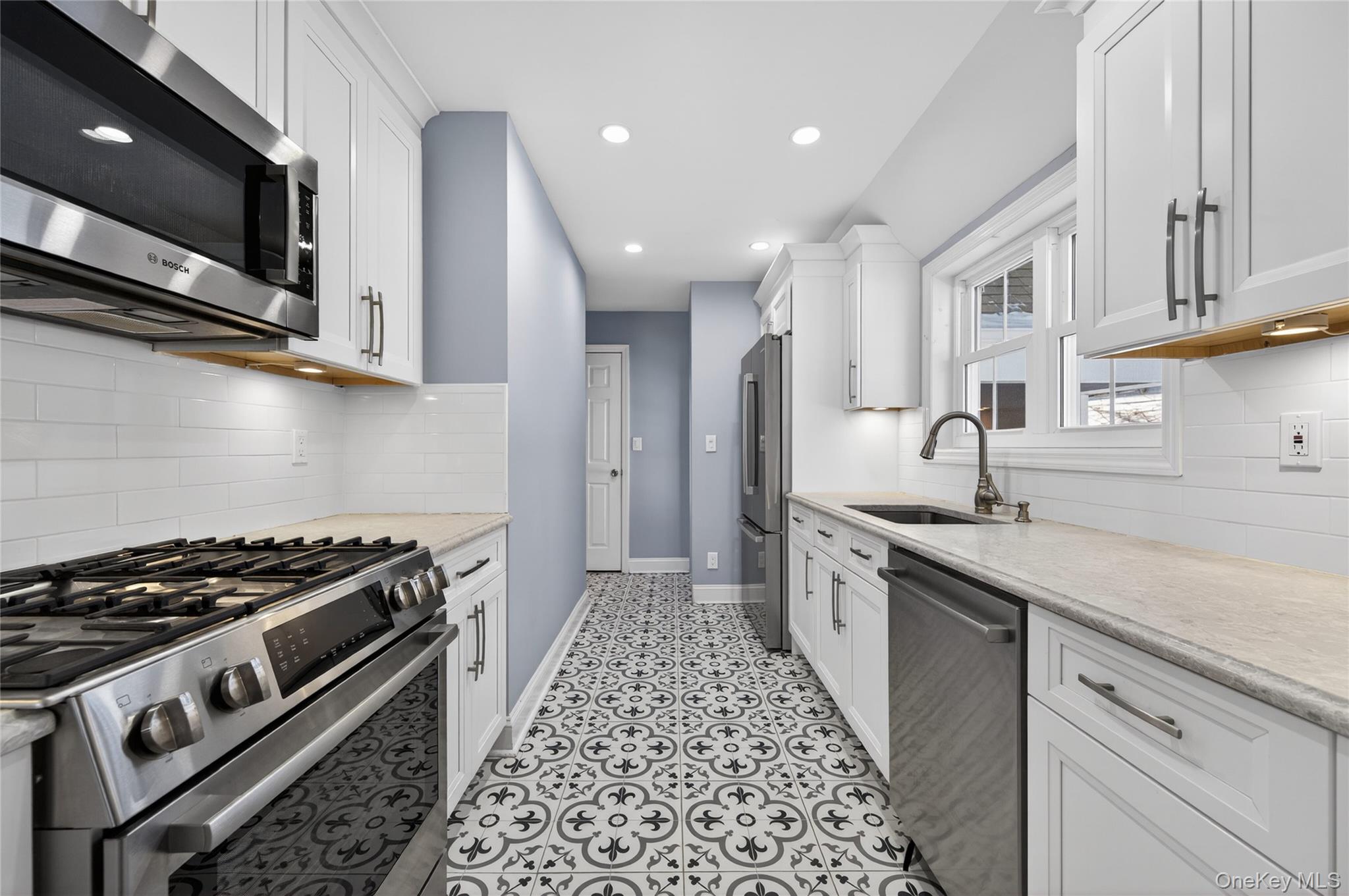 108 La Rue Drive Huntington, NY 11743 - Photo 9 of 27 Kitchen featuring stainless steel appliances, white cabinets, recessed lighting, backsplash, and light tile patterned floors