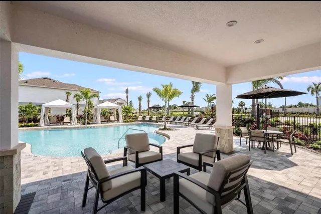 a dining room with furniture and a floor to ceiling window