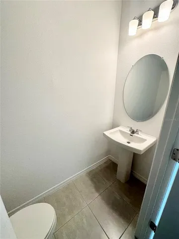 a bathroom with a sink toilet and mirror