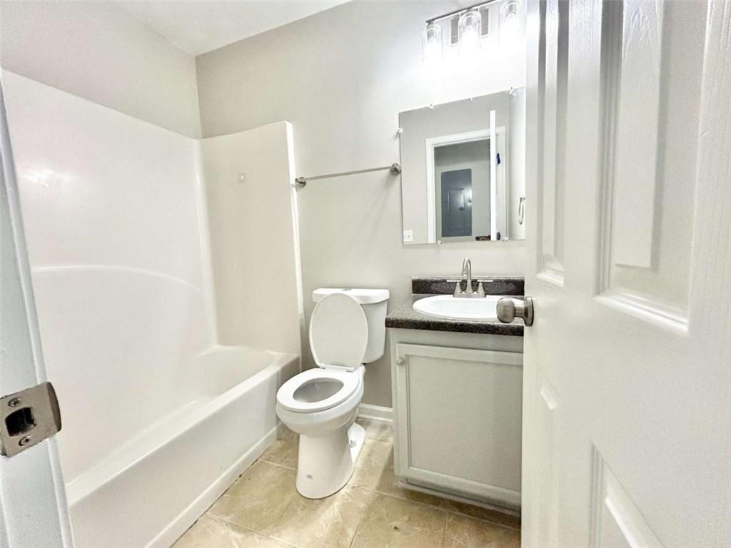 739 Wheel House Lane, Unit A Monroe, GA 30655 - Photo 16 of 17 a bathroom with a sink toilet and shower