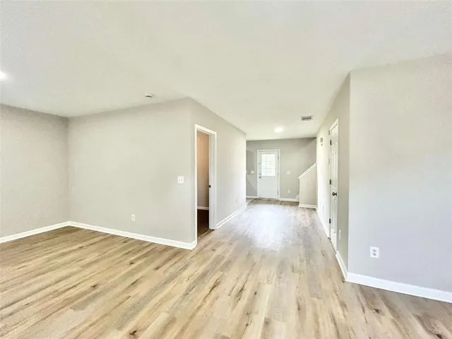 a view of a room with wooden floor