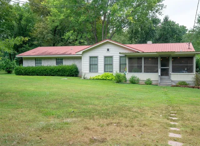 a front view of house with an outdoor space and swimming pool