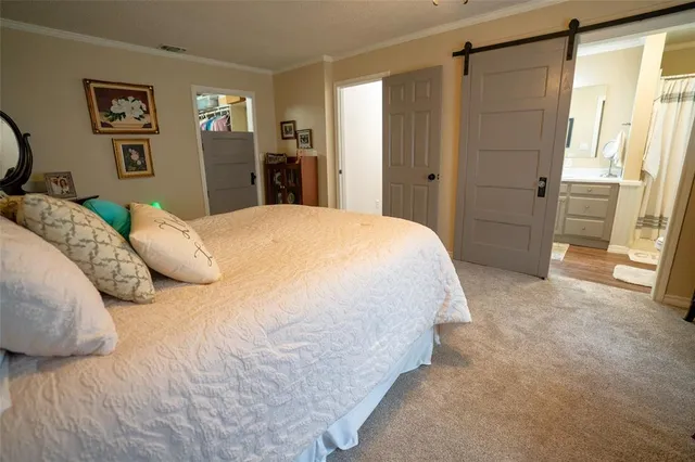 a spacious bedroom with a bed and a mirror