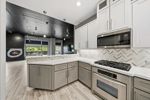 a kitchen with granite countertop a stove and a sink