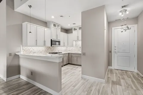 a kitchen with kitchen island a sink stainless steel appliances and cabinets
