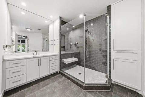 a bathroom with a shower sink and mirror