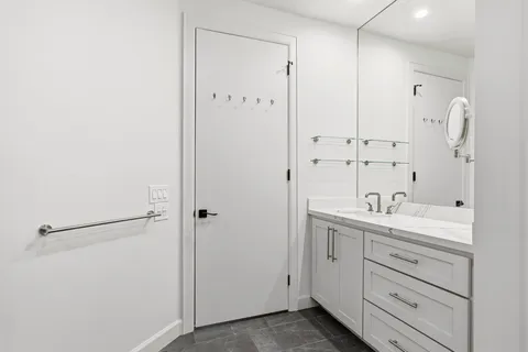 a spacious bathroom with a shower sink and mirror