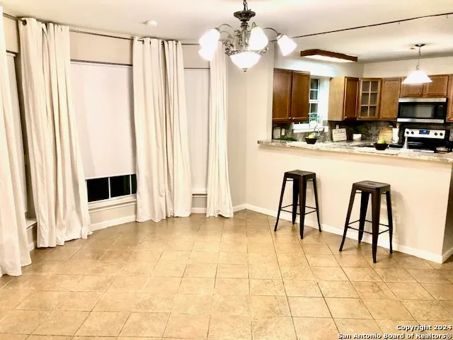 a view of kitchen with furniture and stainless steel appliances