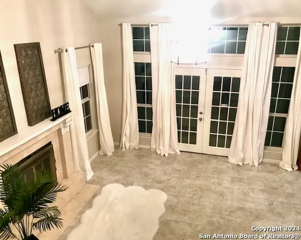 a view of an empty room with a fireplace