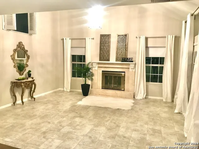 a view of a livingroom with a fireplace and a window