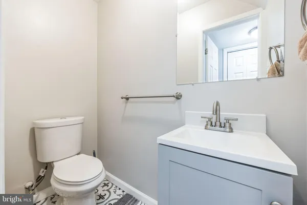 a bathroom with a sink toilet and a mirror