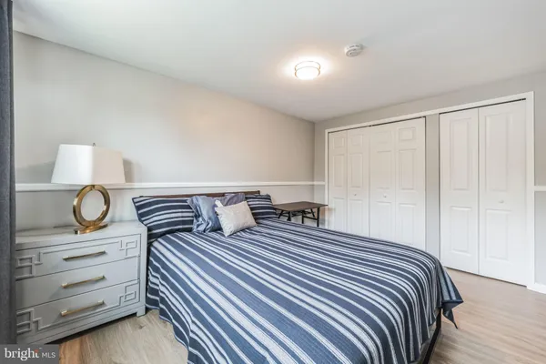 a bedroom with a bed and cabinet