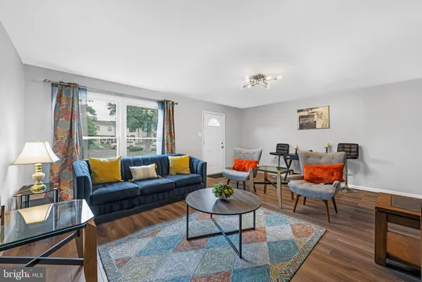 a living room with furniture a rug and a large window