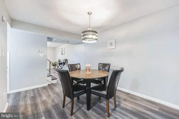 a view of a dining room with a table and chairs