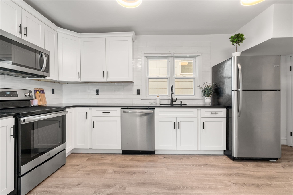 20 Pleasant View Avenue Everett, MA 02149 - Photo 1 of 22 a kitchen with granite countertop a refrigerator stove and microwave