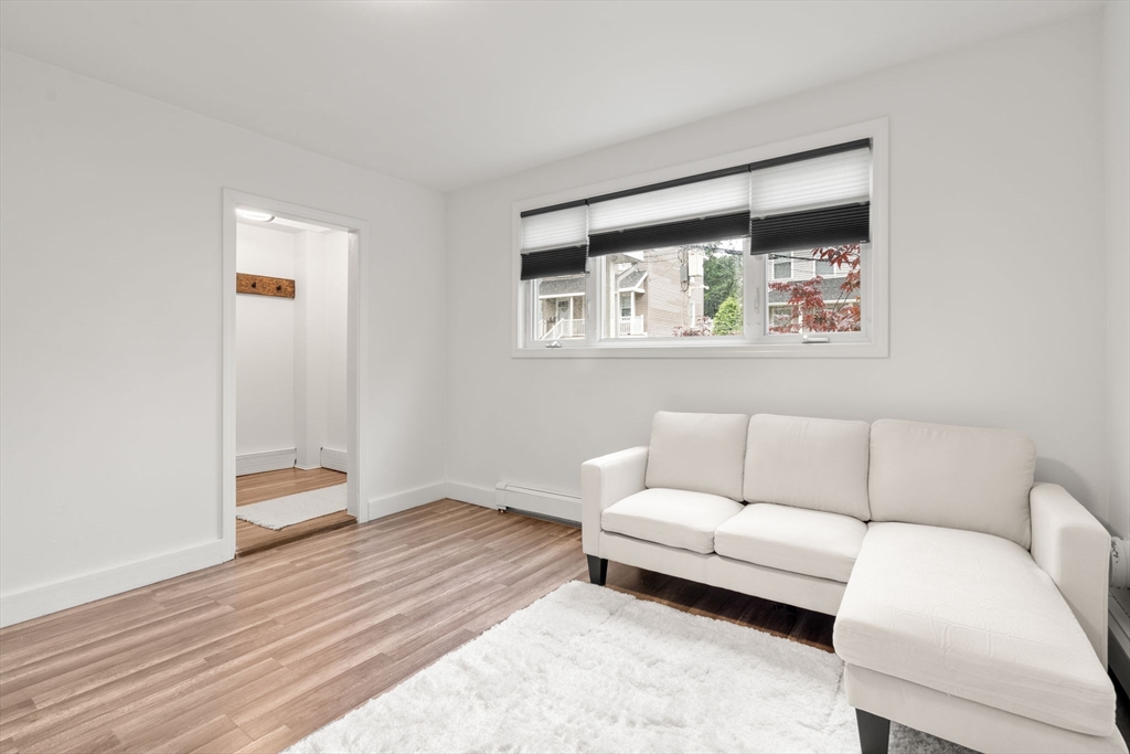 20 Pleasant View Avenue Everett, MA 02149 - Photo 13 of 22 a living room with furniture and a wooden floor