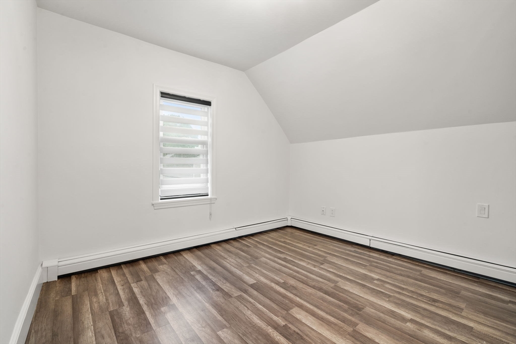 20 Pleasant View Avenue Everett, MA 02149 - Photo 19 of 22 a view of an empty room with wooden floor and a window