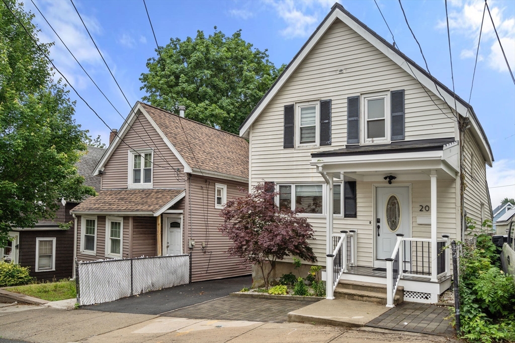 20 Pleasant View Avenue Everett, MA 02149 - Photo 2 of 22 a view of a white house with large windows and plants