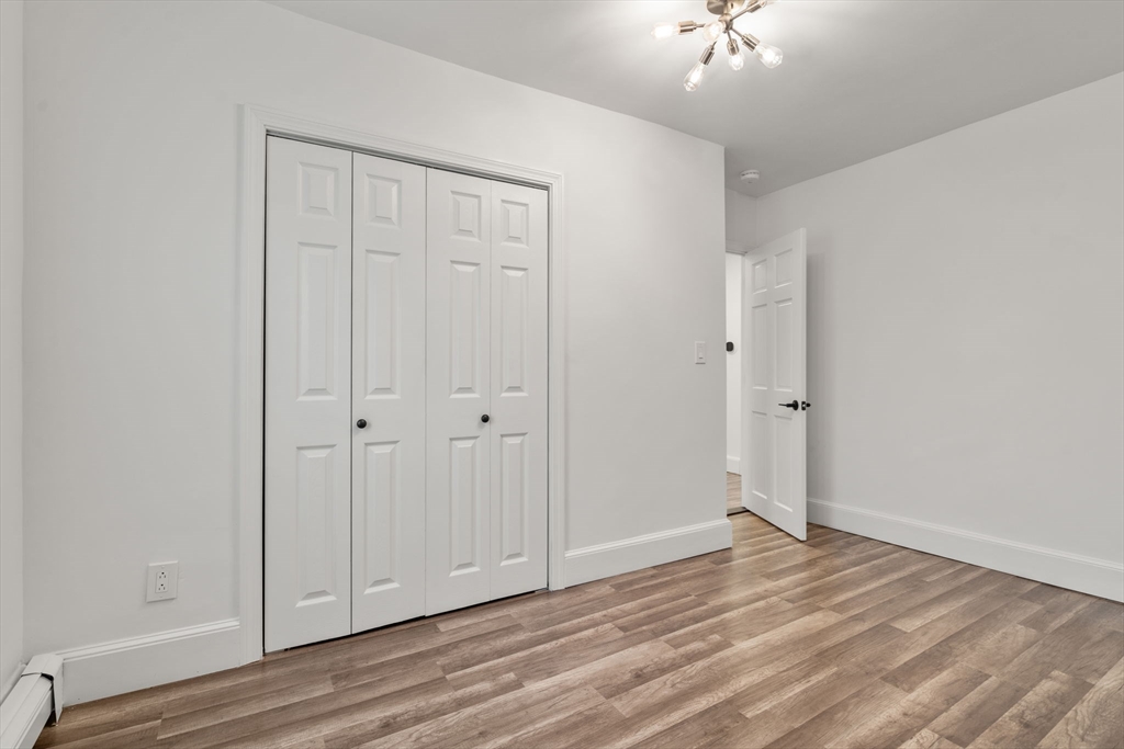 20 Pleasant View Avenue Everett, MA 02149 - Photo 21 of 22 a view of a livingroom with wooden floor and a ceiling fan