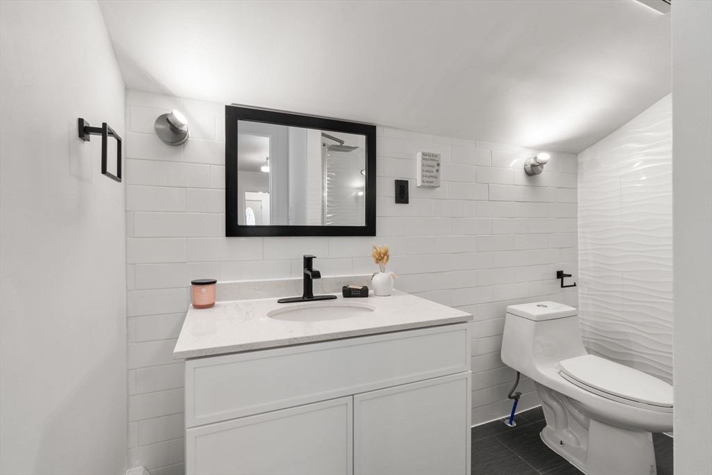 20 Pleasant View Avenue Everett, MA 02149 - Photo 7 of 22 a bathroom with a toilet a sink and mirror