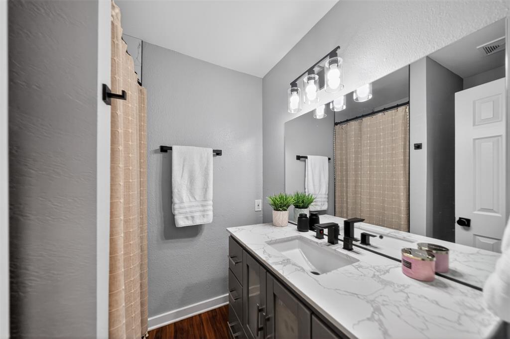 614 Colonial Drive Athens, TX 75751 - Photo 22 of 26 a bathroom with a granite countertop sink and a mirror