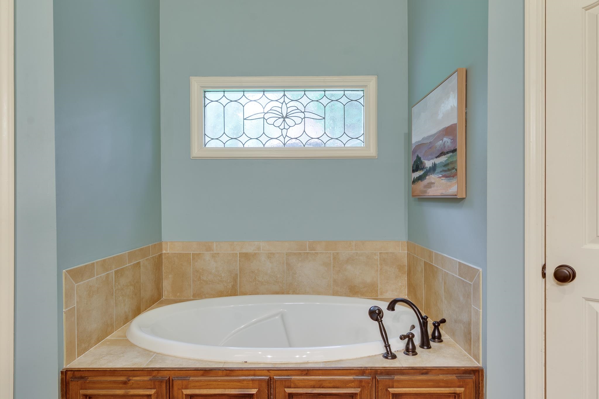791 North Tree Drive Collierville, TN 38017 - Photo 15 of 27 Built-in soaking tub with a tiled surround and wood-finish cabinetry