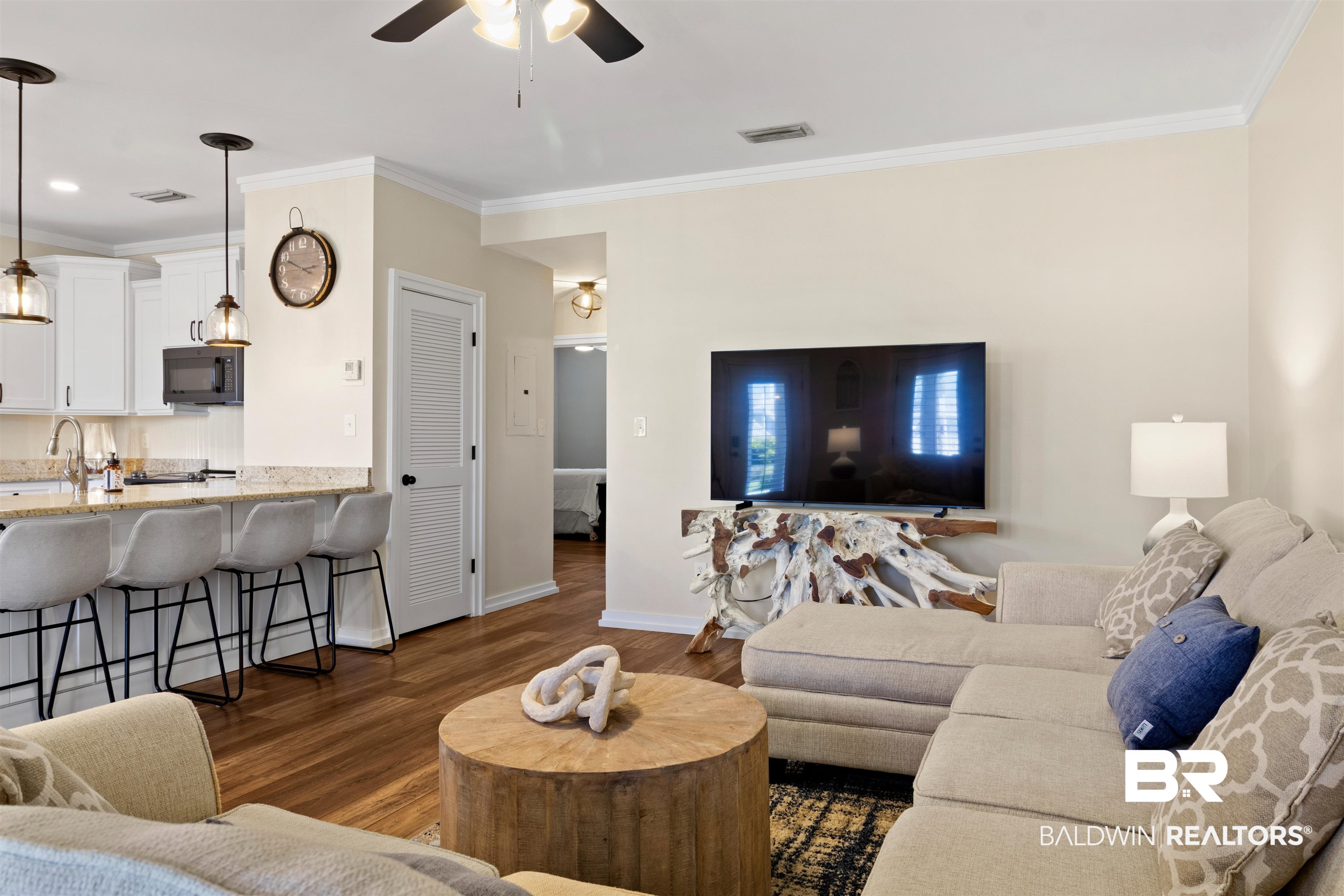 3543 Bayou Road, Unit 5 Orange Beach, AL 36561 - Photo 11 of 33 Open-concept living space featuring wood-finish flooring, white crown molding, and a ceiling fan