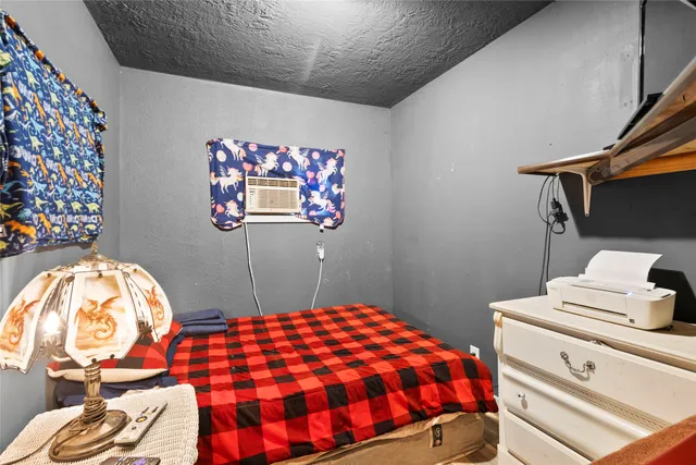 a bedroom with a bed couch and a ceiling fan