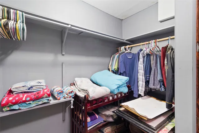 a bedroom with a bed and a lamp