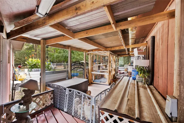 a view of balcony with wooden floor and seating space