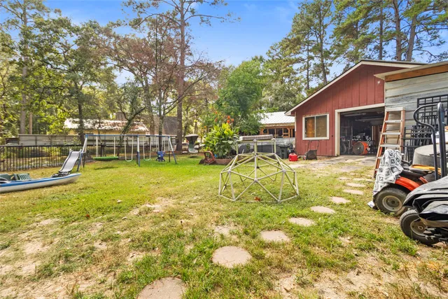 a view of a swimming pool with lawn chairs and plants