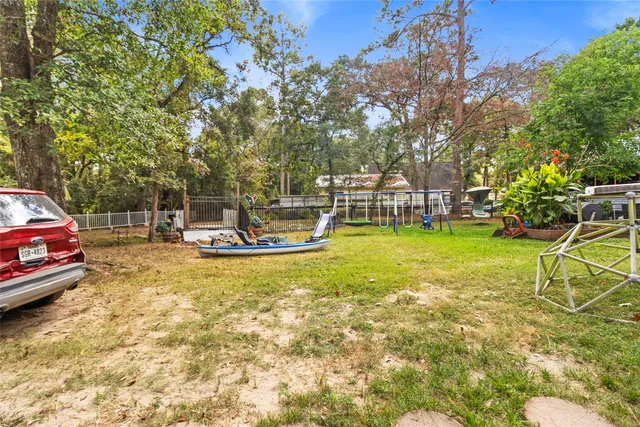a view of backyard with deck and a slide