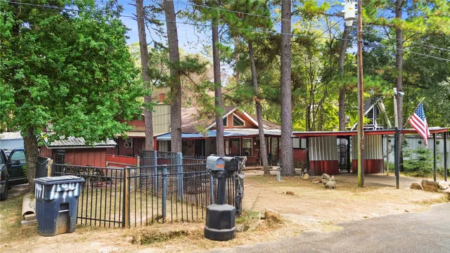 an aerial view of residential house with outdoor space and trees all around