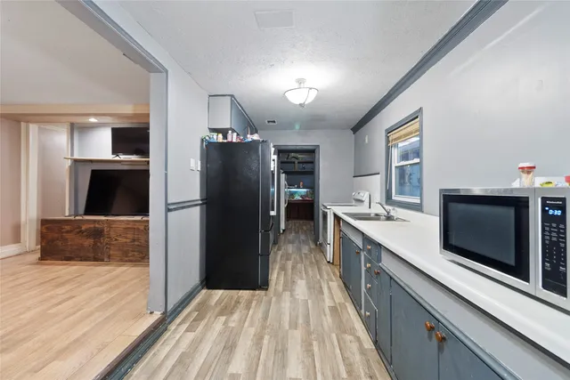 a kitchen with a sink stove and refrigerator