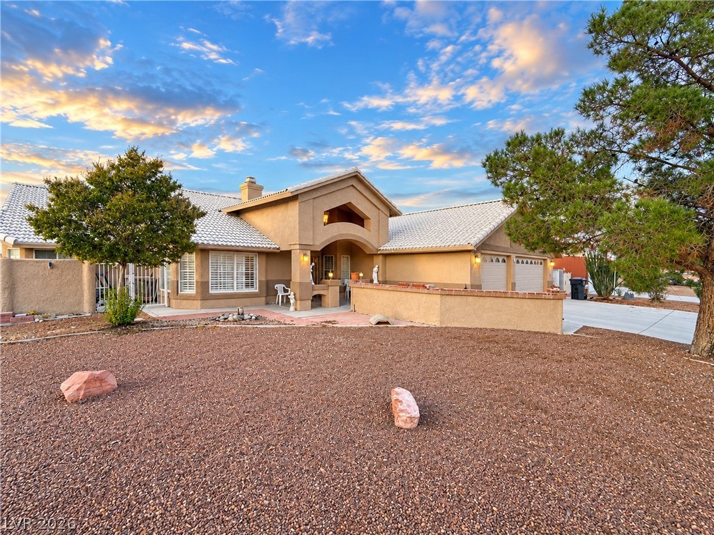 5470 Grain Mill Road Pahrump, NV 89061 - Photo 1 of 80 RV parking. Stucco exteriors and tiled roofing define this southwest-style home set against desert landscaping.
