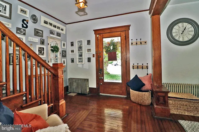 a living room with furniture a fireplace and wooden floor